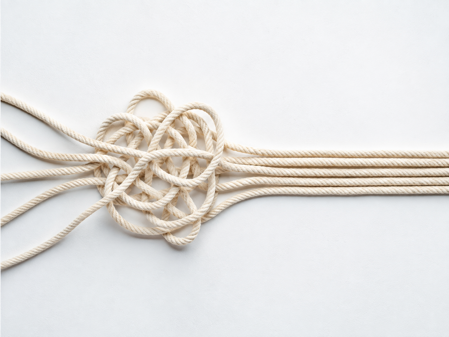 A tangled bundle of rope resolving into straight parallel strands